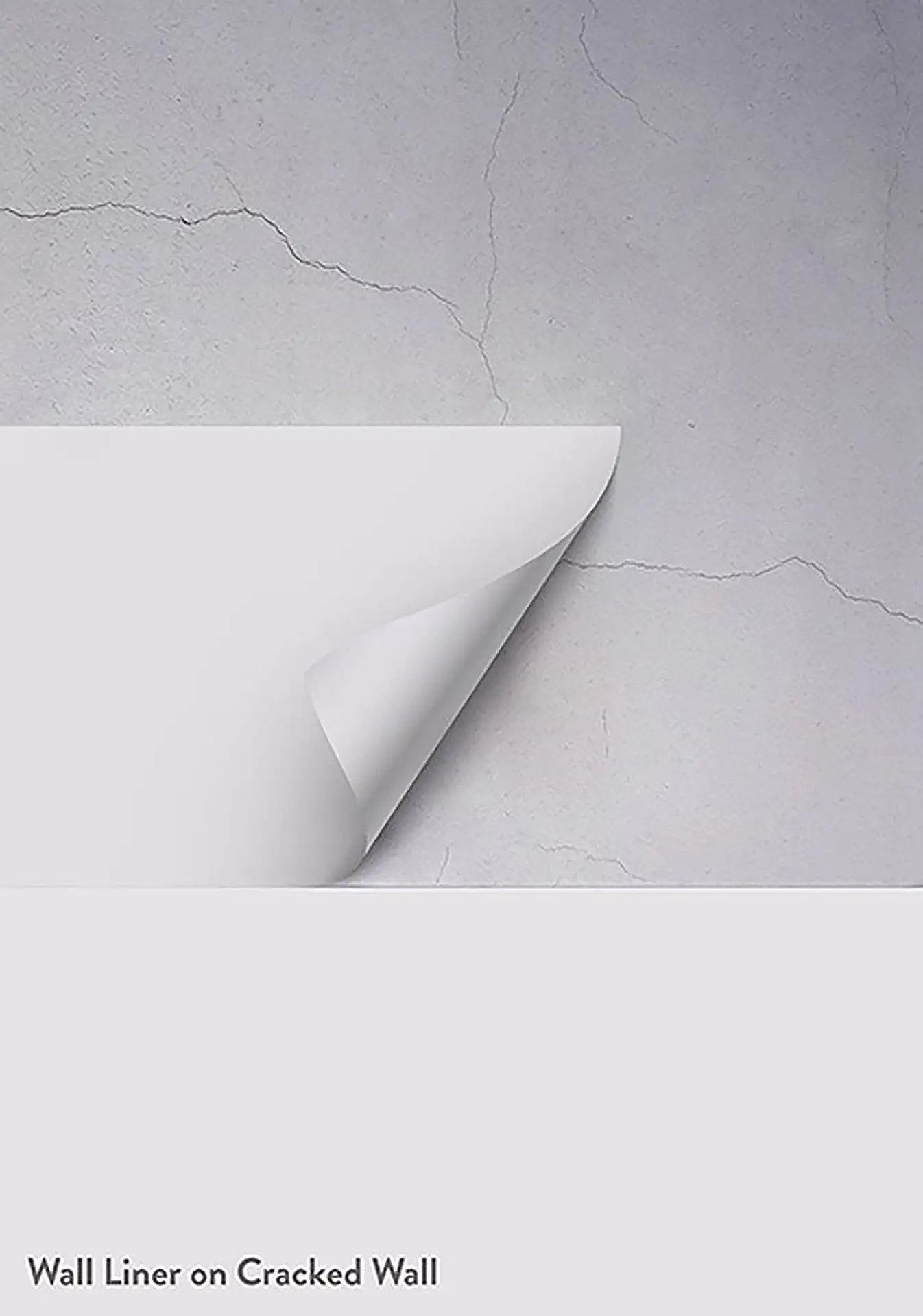 A cracked wall with lining paper being applied